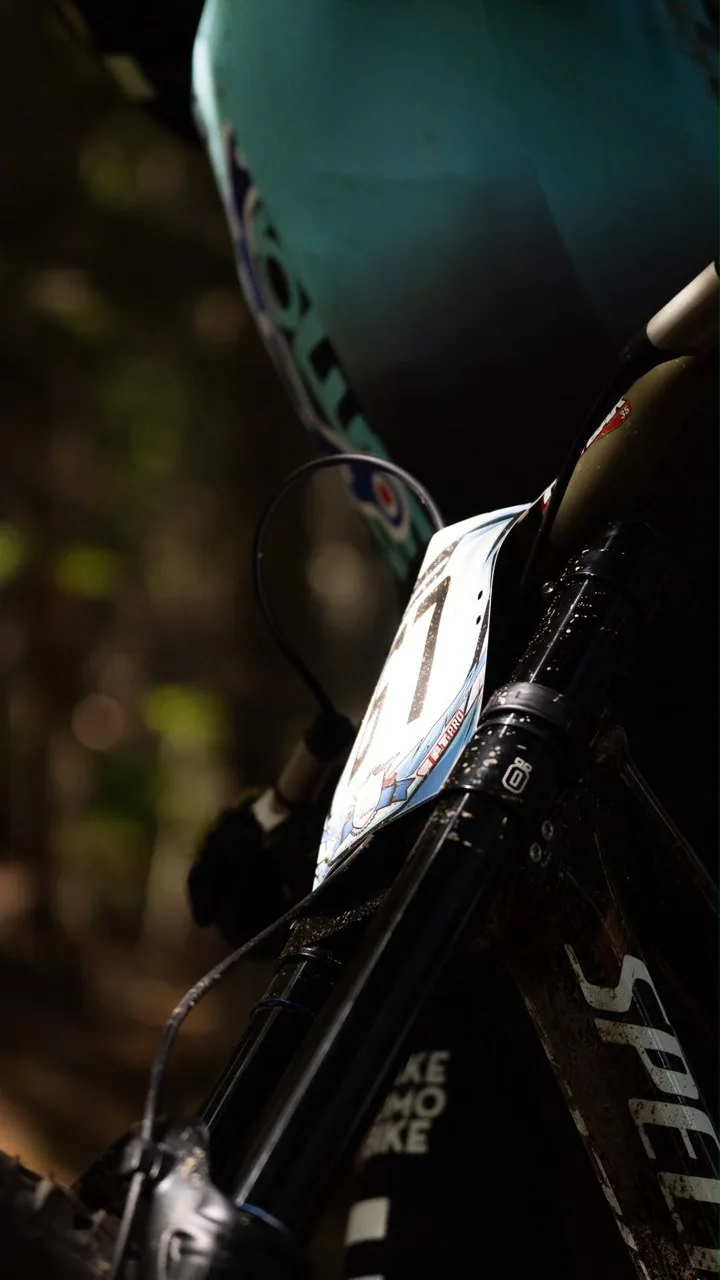 Downhillitalia — bike detail in the woods before a run