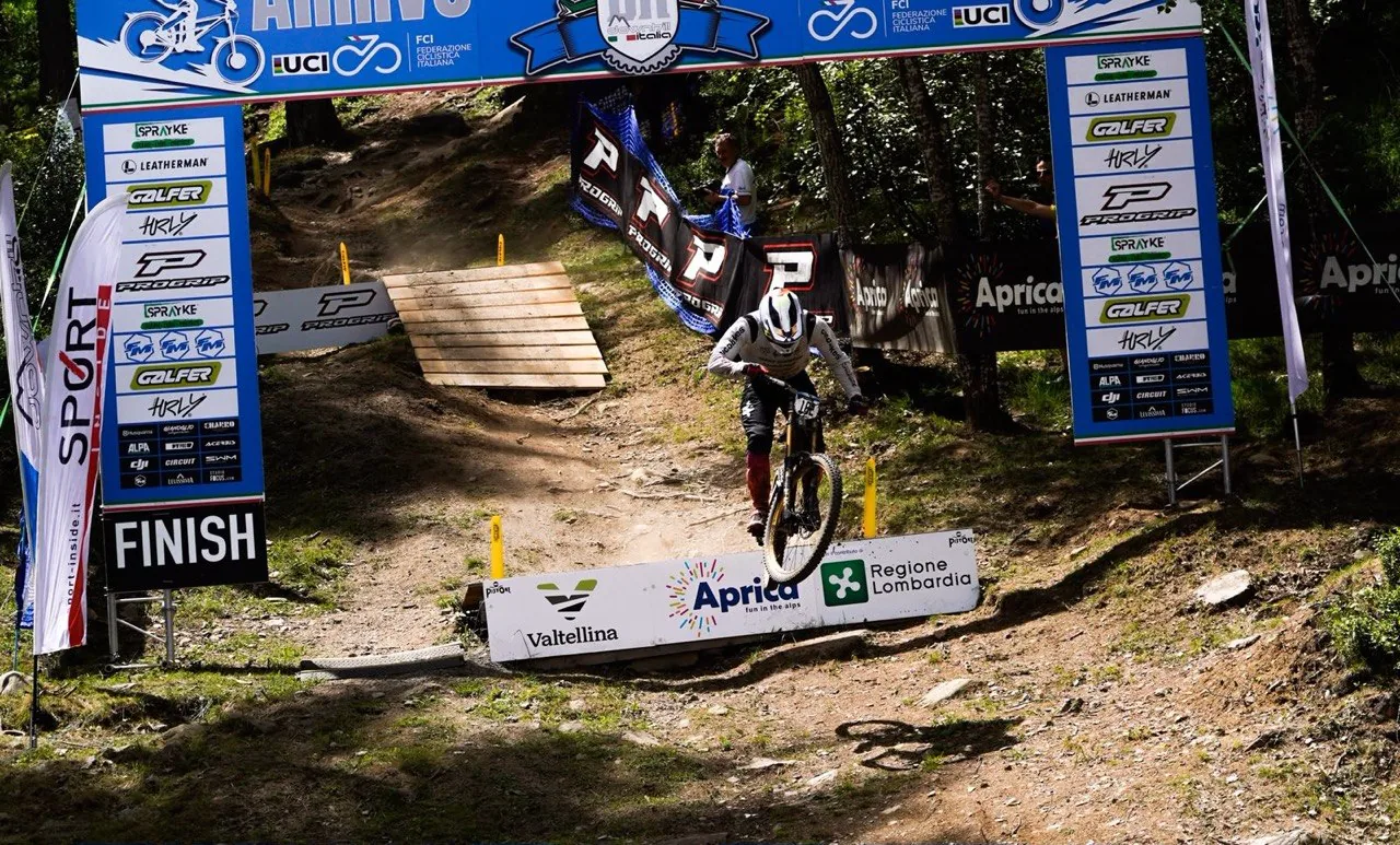 Downhillitalia — a rider crossing under the finish gate